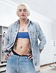 A beautiful ladyboy is standing on the street and posing for money