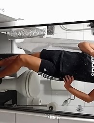 A seductive African American transgender woman reveals her phallus from a rear angle