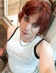 Kellycd2022, the amateur crossdresser, flaunts her seductive charm in a provocative pink bodysuit.